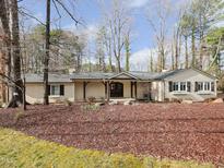 Charming one-story home with a covered front porch and well-maintained landscaping at 1200 Manchester Dr, Raleigh, NC 27609