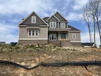 New construction home featuring a mix of siding and brick with a craftsman style front door at 165 Cotton Fields Ln # 25, Fuquay Varina, NC 27526