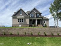 Striking two-story home showcases mixed siding, brick accents, and manicured landscaping, enhancing its curb appeal at 165 Cotton Fields Ln # 25, Fuquay Varina, NC 27526
