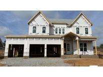 Under construction home featuring a two-car garage and covered porch at 2317 Eagle Shot Ct # 30, Fuquay Varina, NC 27526