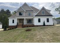 Stunning two-story home boasting a modern design with mixed siding and a covered front porch at 318 Deer Tail Ln # 35, Fuquay Varina, NC 27526