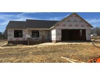 Unfinished exterior of a single-Gathering home featuring an attached garage and brick foundation at 39 N Movado Trl, Kenly, NC 27542