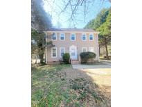 Charming two-story home with traditional architecture, manicured lawn and landscaped front yard with trees at 4204 Labrador Dr, Raleigh, NC 27616