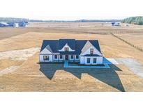 Gorgeous new construction home featuring a welcoming front porch and ample land for privacy at 525 Sanctuary Trl, Cameron, NC 28326