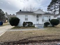 Charming home featuring a welcoming front porch and neatly trimmed landscaping at 528 Mill St, Smithfield, NC 27577
