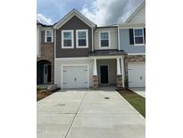 Charming multi-tone townhome featuring a one-car garage, neutral siding, and stone accents at 605 Leland Hl Cir, Zebulon, NC 27597