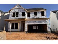 Two-story home construction featuring durable Tyvek HomeWrap and an attached two-car garage at 63 Daybreak Way, Fuquay Varina, NC 27526