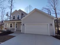 Charming two-story home with a covered porch and two-car garage, perfect for Gathering living and curb appeal at 632 Angus Ct, Sanford, NC 27332