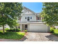 Charming two-story home with attached two-car garage, well-maintained lawn, and mature trees at 634 Conover Rd, Durham, NC 27703