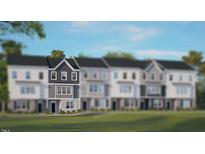 Charming townhome with a modern design and well-manicured lawn, showcasing curb appeal at 821 Washington St, Fuquay Varina, NC 27526