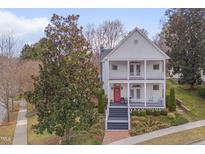 Charming two-story white home with a welcoming red door and double front porches at 101 Overlake Dr, Chapel Hill, NC 27516