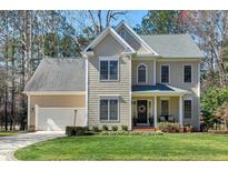 Two-story home featuring a two-car garage, a gabled roof, and a well-maintained front lawn at 104 Musgrove Cir, Cary, NC 27518