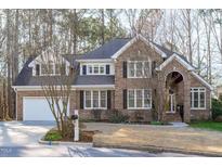 Charming two-story brick home with a well-manicured lawn and attached two-car garage at 126 Maltland Dr, Cary, NC 27518