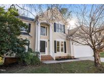 Charming two-story home featuring a classic design, well-manicured lawn, and a welcoming entrance at 215 Longbridge Dr, Cary, NC 27518