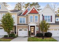 Charming townhome with a brick facade, attached garage, and well-manicured landscaping at 357 Roberts Ridge Dr, Cary, NC 27513