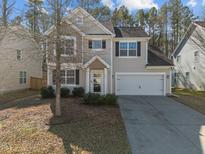 Charming two-story home with a two-car garage, well-maintained landscaping, and a welcoming front entrance at 445 Walsenburg Dr, Durham, NC 27712