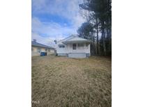 Charming single-story home with a quaint front porch and lawn at 4805 Barbee Rd, Durham, NC 27713