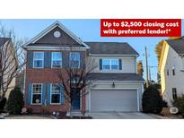 Charming two-story home featuring a brick facade, blue shutters, and an attached two-car garage at 508 Stapleford Ln, Fuquay Varina, NC 27526