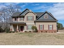 Charming two-story home featuring a well-maintained lawn, inviting curb appeal, and a classic design at 5439 Cokesbury Rd, Fuquay Varina, NC 27526