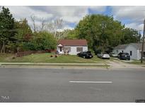 Charming single-story home featuring a well-maintained lawn and seasonal decorations at 829 N Beckford Dr, Henderson, NC 27536