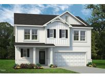 Charming two-story home featuring a light exterior, a welcoming entryway, and an attached two car garage at 73 Merle Dr, Wendell, NC 27591