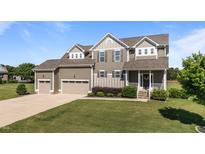Charming two-story home with a manicured lawn and a three-car garage on a sunny day at 124 Brookstone Way, Angier, NC 27501