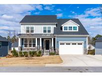 Beautiful two-story home with a two-car garage and a manicured front yard on a sunny day at 124 Ferrell W Rd, Apex, NC 27523