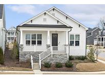 Charming single-story home with white siding, a stone foundation, and a welcoming front porch at 1737 Fence Post Rd, Wendell, NC 27591