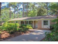 Charming brick home featuring a well-manicured front yard and a welcoming covered entry at 2201 Knollwood Dr, Sanford, NC 27330