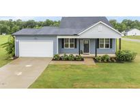 Charming single-Gathering home with a well-manicured lawn and attached garage at 251 Olde Pl, Zebulon, NC 27597