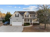 Charming two-story home with attached two-car garage and manicured front lawn at 32 Harkers Island Dr, Garner, NC 27529