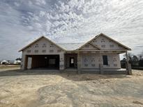 An incomplete charming one-story home featuring a two-car garage under a cloudy sky at 56 Bailey-Boykin Rd, Selma, NC 27576