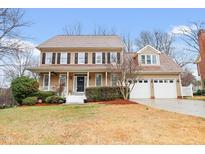 Charming two-story home with a welcoming front porch and well-maintained landscaping at 101 Camden Branch Dr, Cary, NC 27518