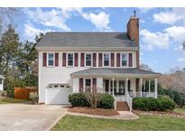Charming two-story home with white siding, red shutters, attached garage and covered front porch at 1313 Glencastle Way, Raleigh, NC 27606