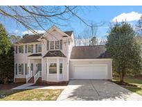 Charming two-story home with attached two-car garage, bay window and a well-manicured front yard at 205 Caniff Ln, Cary, NC 27519