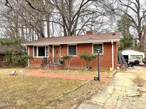 Charming single-story brick home with a walkway leading to the front door at 2607 Sater St, Durham, NC 27703