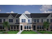 New brick townhomes with black roofs, black doors, and green grass offer contemporary living at 264 Chesapeake Commons St # 155, Garner, NC 27529