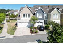 Charming townhome featuring attached garage, manicured landscaping, and a welcoming driveway at 4137 Strendal Dr, Cary, NC 27519