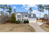Charming two-story home with a well-manicured lawn and attached two car garage at 415 Moonlight Dr, Fuquay Varina, NC 27526