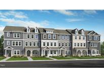 Charming townhomes with a mix of siding, brick, and stone exteriors, complemented by well-manicured lawns at 423 Rowe Way, Knightdale, NC 27545