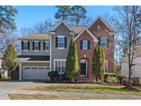 Charming home featuring a combination of brick and gray siding at 4711 Marena Pl, Durham, NC 27707