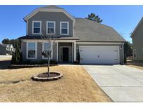 Charming two-story home with a well-manicured lawn and attached two car garage at 5 Misty Grove Trl, Franklinton, NC 27525