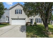 Charming two-story home with a well-manicured lawn and a classic garage at 6306 Winding Arch Dr, Durham, NC 27713