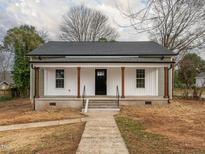 Charming single-story home with a inviting front porch and modern black door at 738 Everett St, Burlington, NC 27215