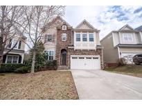 Beautiful two-story home with a stone facade and attached two-car garage at 804 Long Meadows Rd, Chapel Hill, NC 27516