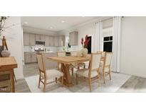 Open-concept dining area featuring a light wood table set with seating for six and views into the kitchen at 81 St Andrews Dr, Zebulon, NC 27597