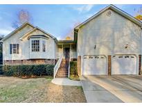 Charming two-story home with a two-car garage and well-manicured landscaping at 8425 Fawncrest Dr, Raleigh, NC 27603