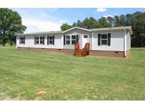 Charming single-story home featuring a well-maintained lawn and classic design at 9115 Nc 157, Rougemont, NC 27572
