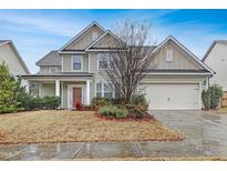 Charming two-story home featuring a well-manicured lawn and an attached two-car garage at 104 Red Bark Ct, Apex, NC 27539
