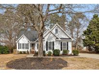 Charming two-story home with a landscaped front yard and inviting curb appeal at 104 Somerset Farm Dr, Holly Springs, NC 27540